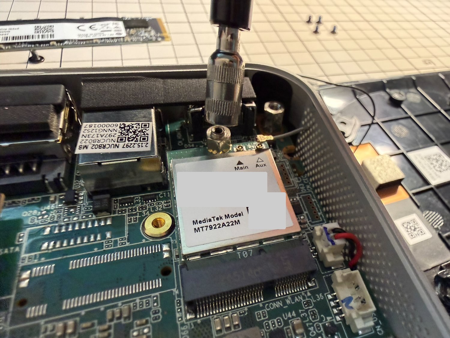 Wi-Fiカード（MT7922）を固定している六角ボルトを工具で回しているところ